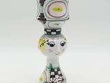 a small vase that has a face on top of it