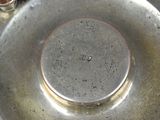 a close up of a metal plate with a small hole in it