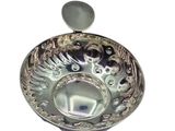 a silver bowl with a spoon in it
