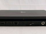 the back of a black laptop computer sitting on top of a white table