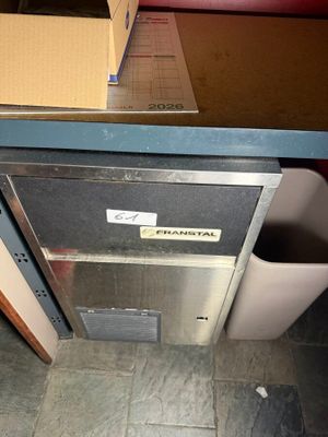 a box that is sitting on the floor next to a trash can
