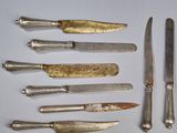 seven knives and a knife on a table