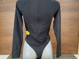a mannequin wearing a wetsuit with a yellow tag on it