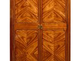 a tall wooden cabinet with two doors and a marble top