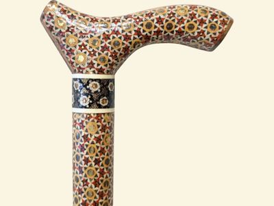 a wooden walking stick with a floral design on it