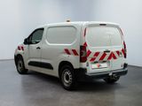 a white van with red and white stripes parked in a room