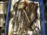 a blue basket filled with silverware and spoons