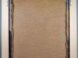 an empty picture frame with a piece of cardboard taped to it