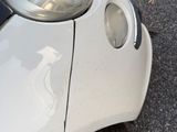 a close up of a car ' s front bumper with a hole in it