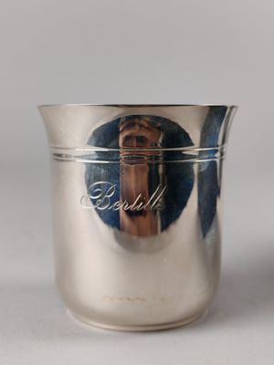 a silver cup with a picture of a woman on it