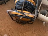 a cart with a bunch of hoses and a pair of shoes
