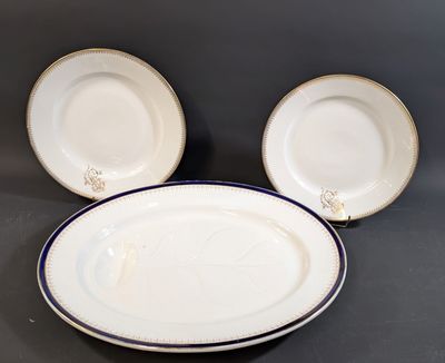 three white plates with blue rims are sitting on a table