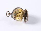a pocket watch that is open on a white surface