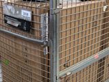 a large metal cage with a bunch of boxes inside of it