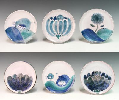 four plates with different designs on them on a white surface