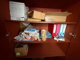 a shelf with a lot of boxes and papers on it
