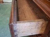 a drawer that is open on the side of a dresser
