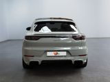 the rear end of a silver porsche cayense parked in a room
