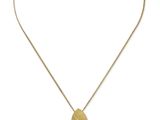 un collier en or avec un pendentif en forme de cœur et une pierre violette