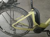 a yellow bicycle parked in a garage with a black seat