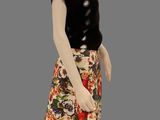 a mannequin dressed in a black top and floral skirt
