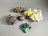 several different colored rocks and stones on a white surface