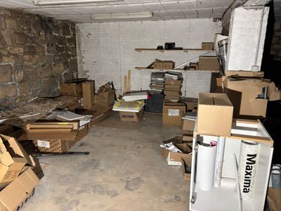 a room filled with boxes and a refrigerator in it