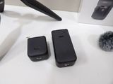 two cell phones sitting on a table next to a microphone