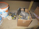 a box of tools sitting on a table next to a bucket of paint