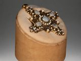 an image of a wooden box with pearls and a star on it