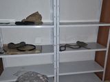 a white book shelf with several shelves on it