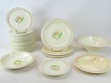 many plates and bowls that are sitting on a table