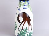 a white vase with a horse painted on it