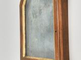 a small mirror hanging on the wall in the corner