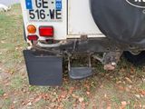a black tire cover on the back of a white truck