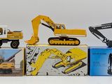 four toy vehicles that are sitting on top of boxes