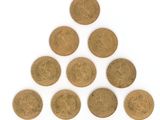 a triangle made out of coins on a white surface