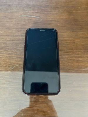 an image of a cell phone sitting on top of a wooden table