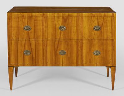 a walnut chest of drawers with brass pulls