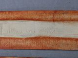 two pieces of cloth with writing on them sitting on a table