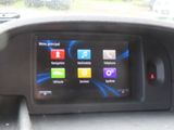 the dashboard of a car with a display of apps on the screen