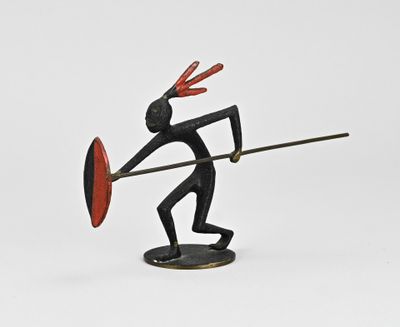 figurine of a man with a spear and shield on a white background