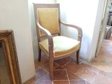 a chair that is sitting next to a picture on the floor