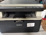 a black and white printer sitting on top of a box