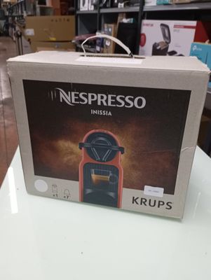 nespresso nesa krups coffee machine in a box on a table