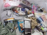 a pile of clothes and other items in a trash can