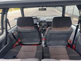 two seats in the back of a van with a steering wheel
