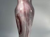 a vase that is sitting on a white surface
