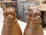 two brown vases that are sitting on a table