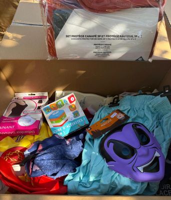 a cardboard box filled with clothing and other items